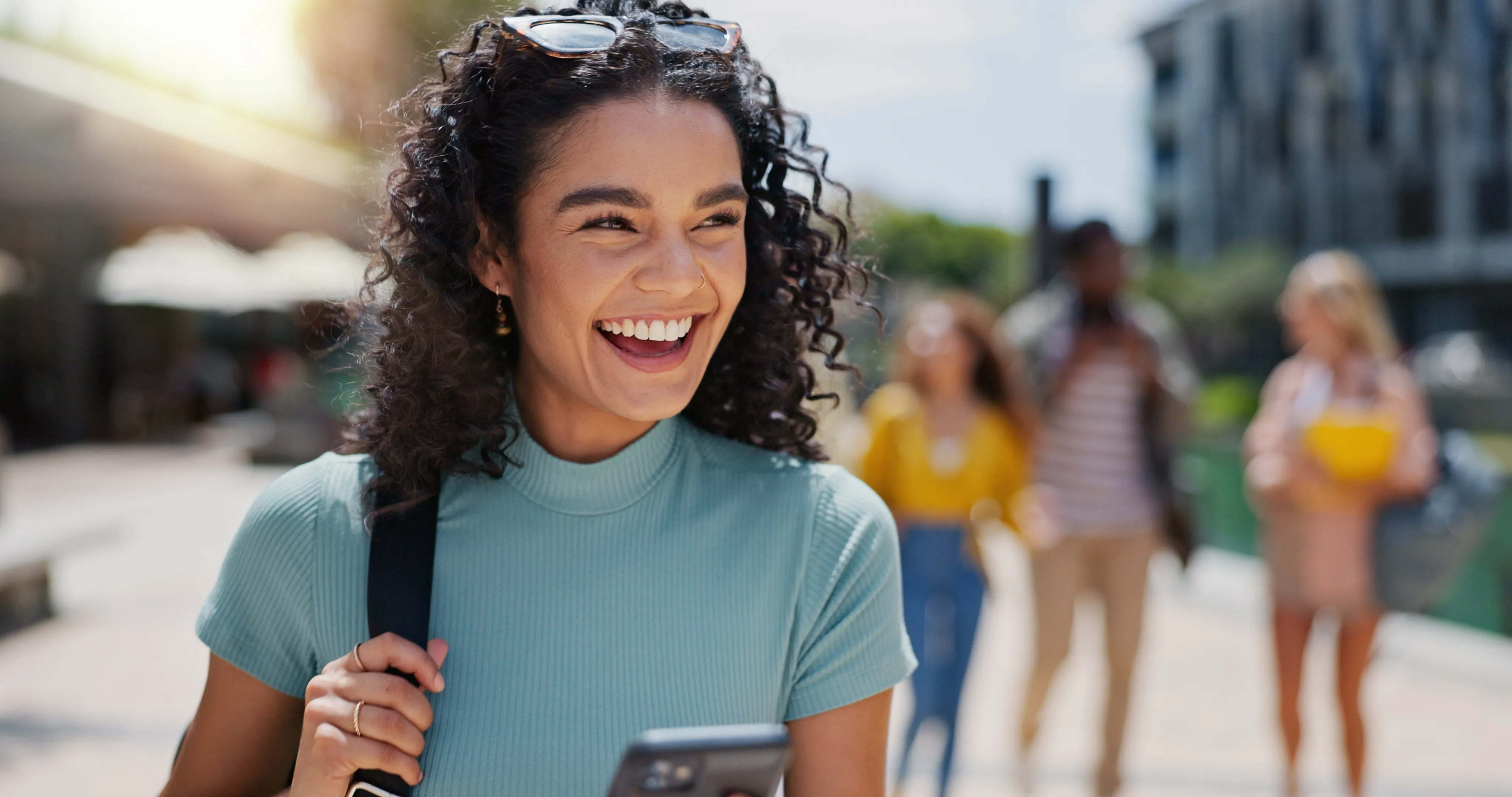 A young adult smiling outdoors