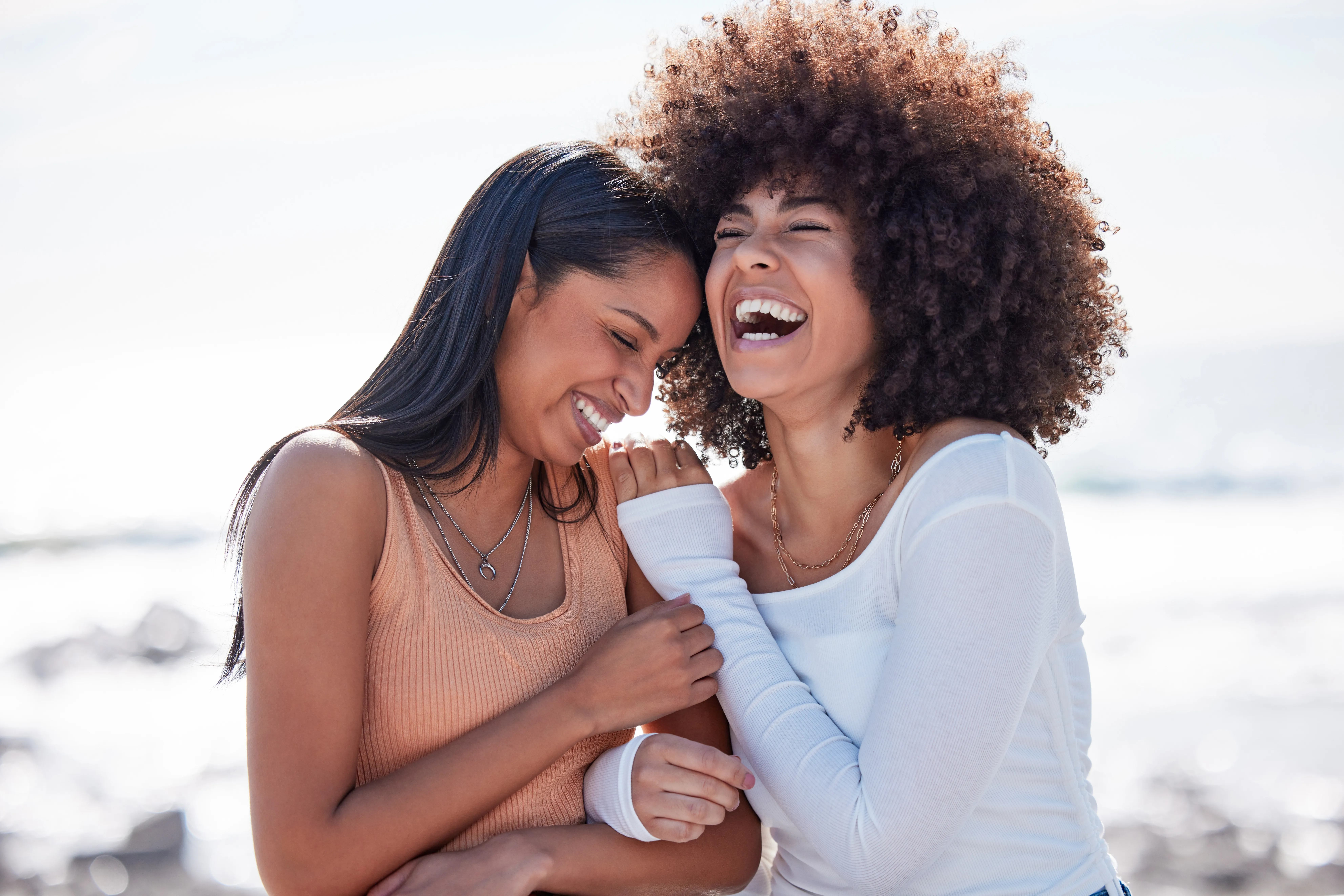 Two friends laughing outdoors